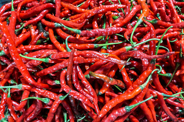 Stacks of red kerting chilies are sold in the market