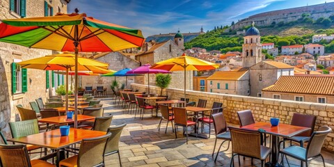 Naklejka premium Open street terrace cafe with colorful umbrellas and tables overlooking the historic buildings of Dubrovnik