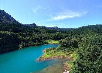 A view of a river flowing through a forest in the countryside.