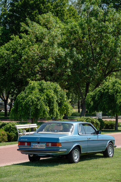 Back-side view of Mercedes-Benz C123 (w123 coupe) 230CE (benzin (petrol), injector 2.3l 1980-1985) in blue color. Palic, Serbia, 08.06.2024 - vertical image