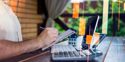 Budget and financial planning concept. Businessman analyzing investment charts with calculator and...