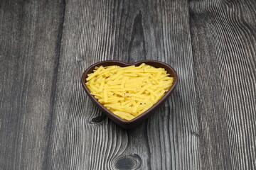 Handmade Turkish Noodles (Turkish Name: Eriste) in bowl. Erishte from Traditional Turkish Cuisine. Vermicelli on wooden background.