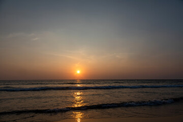 Beautiful sunset in the desert. Desert near the sea. Colorful sky. Warm summer evening.