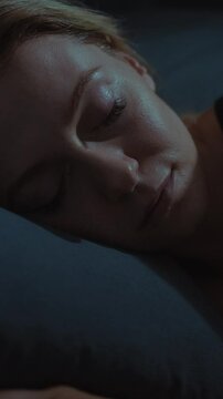 Woman sleeping peacefully in a dimly lit bedroom at night
