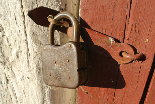 Old iron lock on wooden doors.