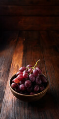 Bunch of Grapes in a Bowl on Wooden Planks with Copy Space