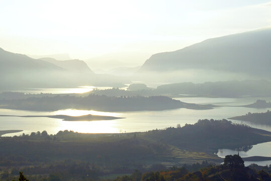 Early morning on Rama Lake (Ramsko jezero): view from above of the water sparkling in the sun, numerous islands and stunning mountains. Natural beauty of Bosnia and Herzegovina.