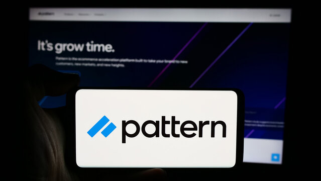 Stuttgart, Germany - 08-19-2024: Person holding cellphone with logo of US e-commerce software company Pattern Inc. in front of business webpage. Focus on phone display.
