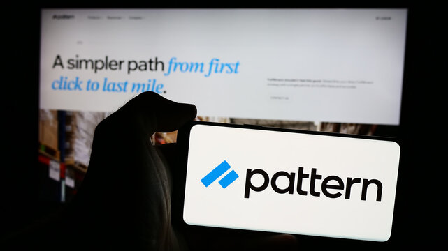 Stuttgart, Germany - 08-19-2024: Person holding mobile phone with logo of American e-commerce software company Pattern Inc. in front of business web page. Focus on phone display.