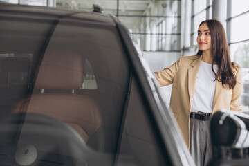 Woman, portrait and smile at car dealership with sale, payment and purchase of new motor. Shopping,...