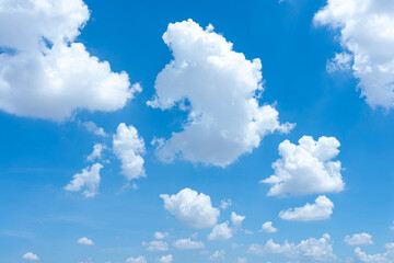 A bright blue sky with fluffy white clouds on a sunny day
