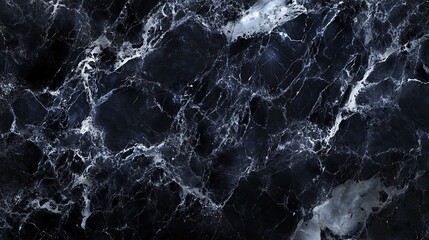 Naklejka premium A close-up shot of a black marble surface with intricate white veining patterns.