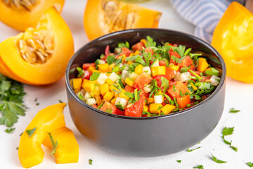Autumn pumpkin and vegetable salsa. Mexican pumpkin, fresh vegetable and corn salad. Healthy vegetarian food, copy space