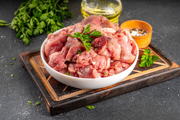 Veal, beef red meat raw chopped goulash, with herbs, condiment, olive oil and spices, cooking dinner background copy space