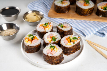 Gimbap or kimbap, korean rolls, traditional dish. Homemade kimbap roll with ham, vegetables and lettuce