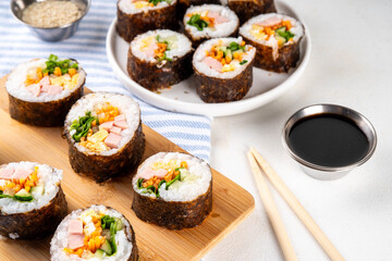 Gimbap or kimbap, korean rolls, traditional dish. Homemade kimbap roll with ham, vegetables and lettuce