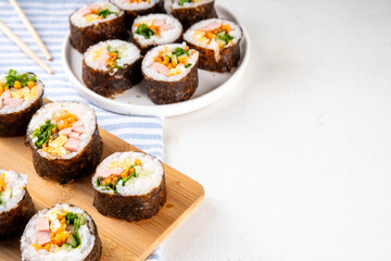 Gimbap or kimbap, korean rolls, traditional dish. Homemade kimbap roll with ham, vegetables and lettuce