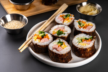 Gimbap or kimbap, korean rolls, traditional dish. Homemade kimbap roll with ham, vegetables and lettuce
