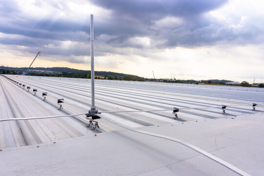 Lightning Protection Pole,lightning protection system to prevent lightning damaging the building is install on metal sheet rooftop building.