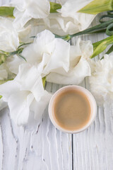 Beautiful bouquet of white carnations and gladioli and coffee