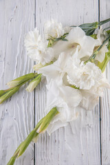 Beautiful bouquet of white carnations and gladiol