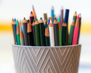 close up of a bunch of colored pencils in a holder