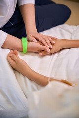 Pediatrician in a hospital ward consoles a patient