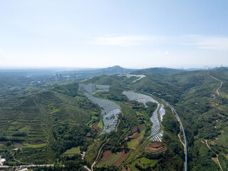 view of solar power station and wind power station on hill