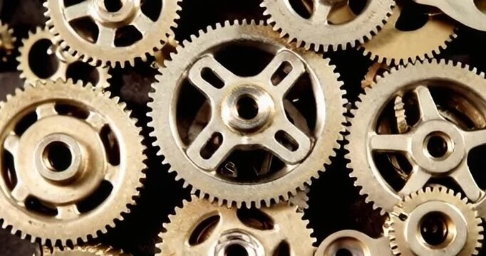 Exploring intricate metal gears and cogs in a vintage steampunk style arrangement on a wooden background