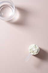Collagen protein powder in a scoop. Top view, copy space