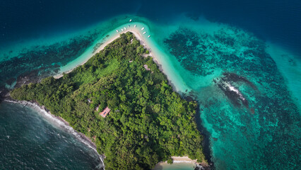 Aerial view of Nosy Tanikely Island in Madagascar showcasing its lush greenery and vibrant turquoise waters