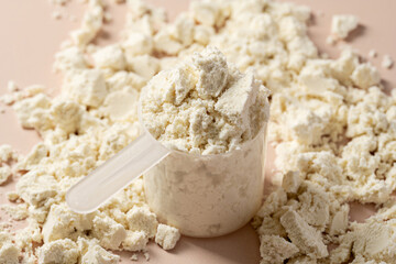 Protein powder. Vanilla flavour of protein powder in scoop, closeup.