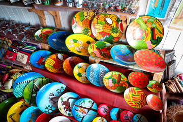 Colorful handmade souvenirs from Madagascar featuring vibrant designs and local artistry displayed in a market setting