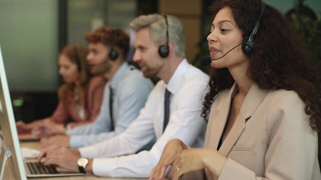 Attractive positive young businesspeople and colleagues in a call center office.