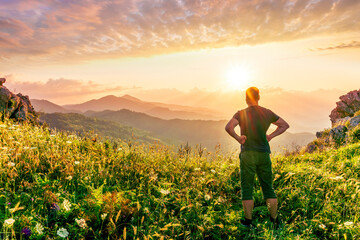 Fototapeta premium happy man watching amazing highland evening sunset, person delight with nature landscape