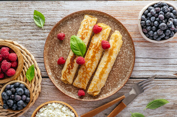 pancakes with cottage cheese and berries on a plate.