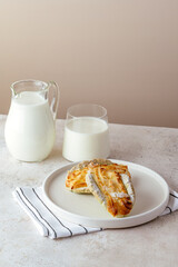 homemade cake on a plate, milk in a glass next to it. healthy br