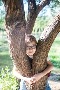 Nice boy resting on the tree