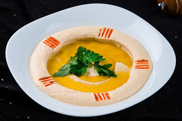 Fresh chickpea hummus with parsley and oil.