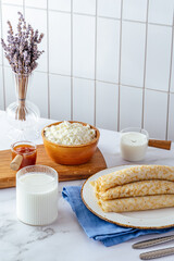 pancakes with cottage cheese on a plate, milk and cottage cheese