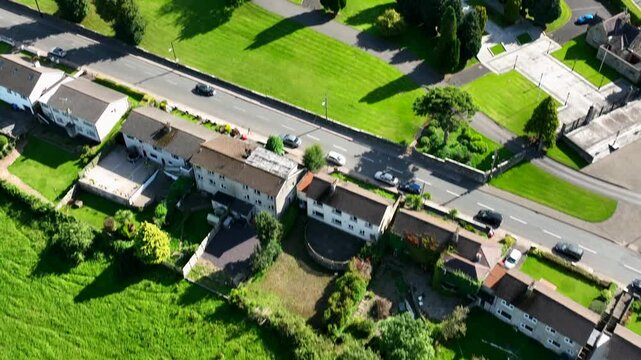 St. Macartan's Cathedral, County Monaghan, Ireland, September 2022. Drone in Bird's Eye view pushes forward over lawns tilting up to reveal the architecture surrounded by trees on a warm sunny day.