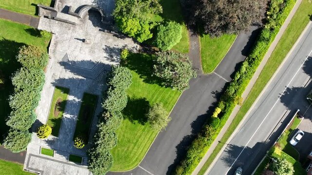 St. Macartan's Cathedral, County Monaghan, Ireland, September 2022. Drone in Bird's Eye view pushes toward the Gothic Revival Church ascending while rotating above the rooftop and spire bell tower.