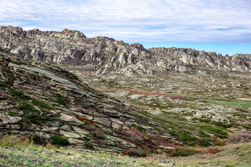 Rocky Mountains Layered Granite. Crumbling Small Mountains in the Steppes of Kazakhstan