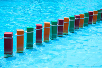 Colorful concrete platforms divide zones at different depths of the swimming pool corridor...