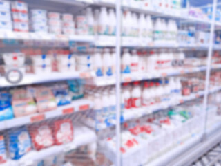 Abstract blur image of supermarket background. Defocused shelves with dairy products. Grocery. Retail industry. Rack. Discount. Inflation and crisis concept. Aisle. Consumer packaged goods. CPG. Store