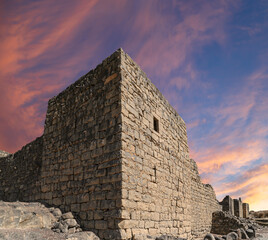 Ruins of Azraq Castle (Qasr al-Azraq) is a crusader castle (300AD),  central-eastern Jordan, 100 km east of Amman, Jordan. Against the background of a beautiful sky with clouds