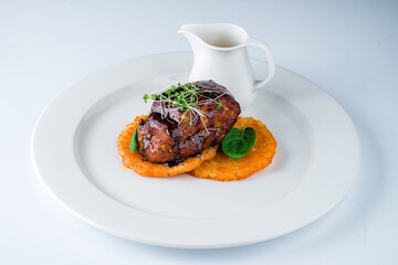 Hot fried potato pancakes with a piece of beef, herbs and sauce.