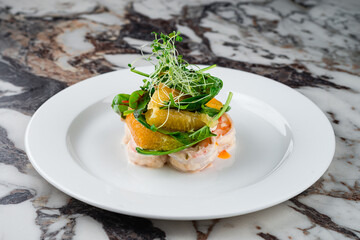 Fresh king prawns in cream sauce with oranges, spinach and microgreens.