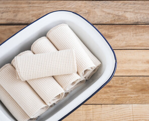 Towels on a white tray with a wooden background