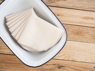 Towels on a white tray with a wooden background